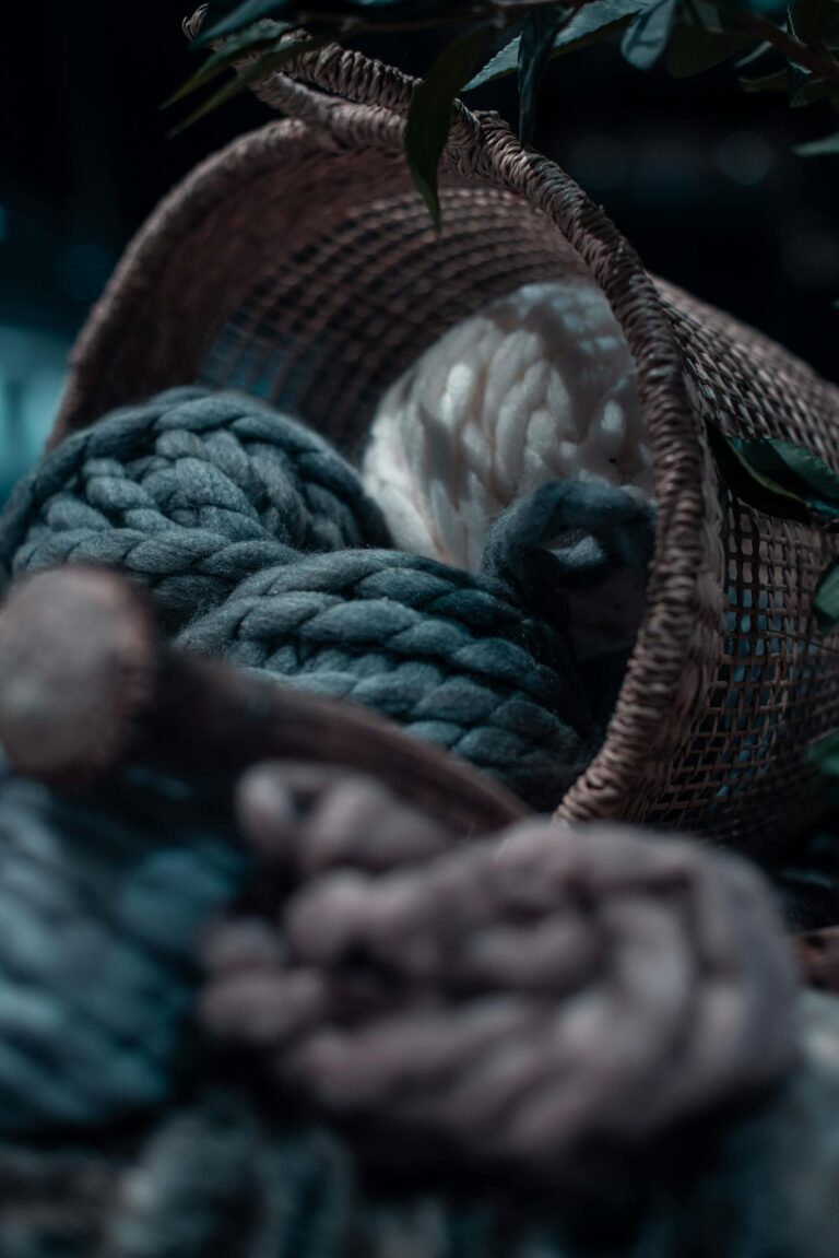 Soft wool yarns spilling from a rustic basket, creating a cozy and warm atmosphere.